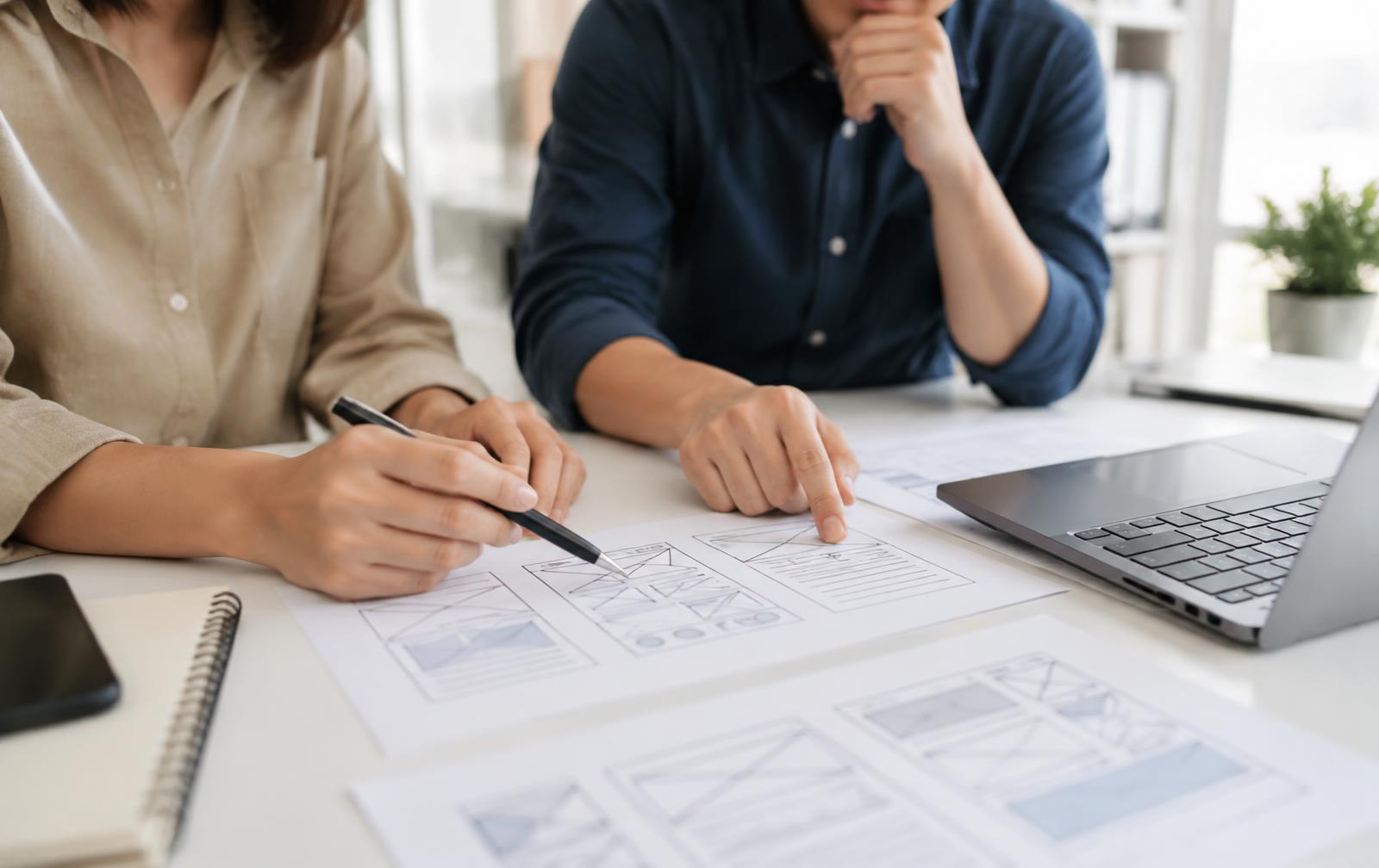 Twee ontwerpers van Web Bouwers bespreken de opbouw van een nieuwe website
